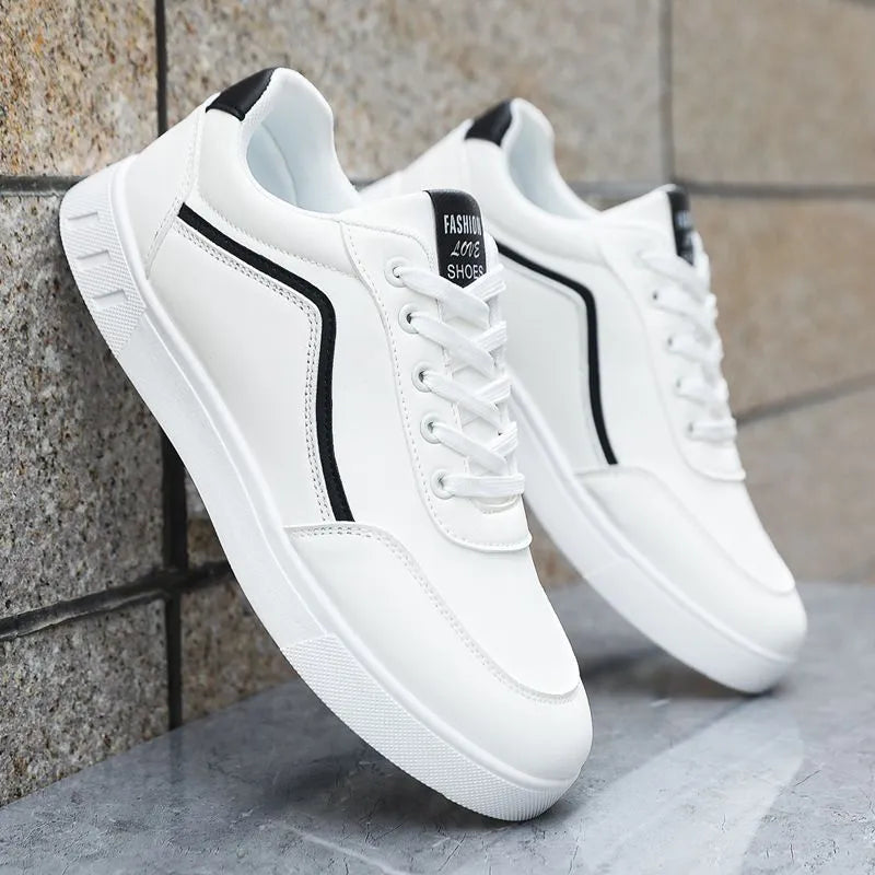 Korean style low top board sneakers in black with white stitching and a flat rubber sole.