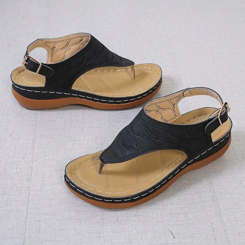 Women's red wedge heel flip flop sandals with an adjustable buckle strap on a white background.