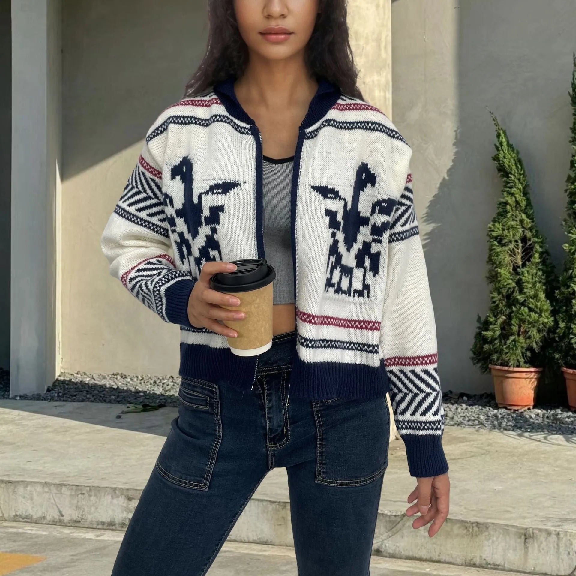 White women's zip-up cardigan with a dark contrast jacquard stripe pattern and a lapel collar.