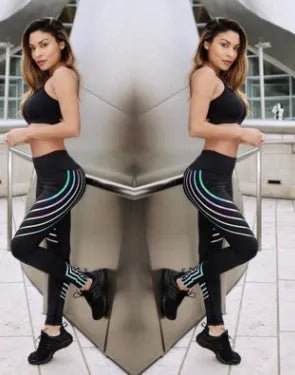 Women's black workout leggings with glowing print design and slim fit pencil pants silhouette