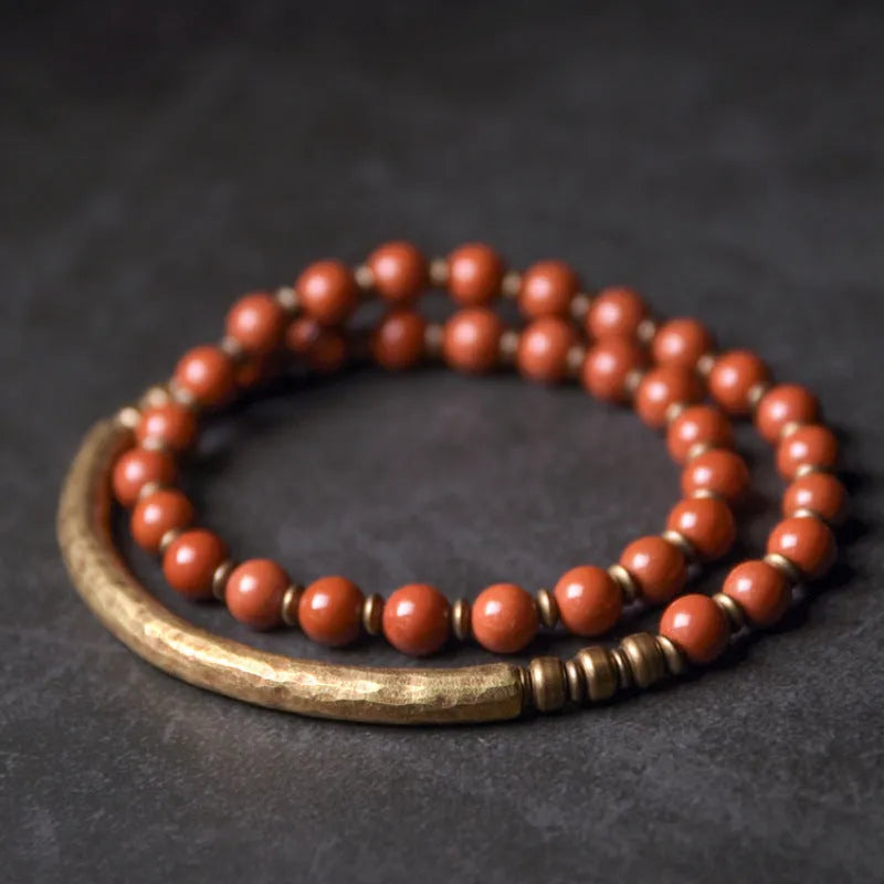 Layered ethnic bracelet with natural stones and brass components on a wrist