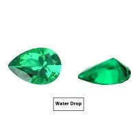 Selection of cultivated Columbia green emerald gemstones in various shapes and sizes on a white background.