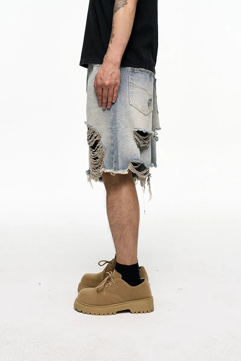 Light blue washed denim shorts with baggy wide leg cut and zipper fly