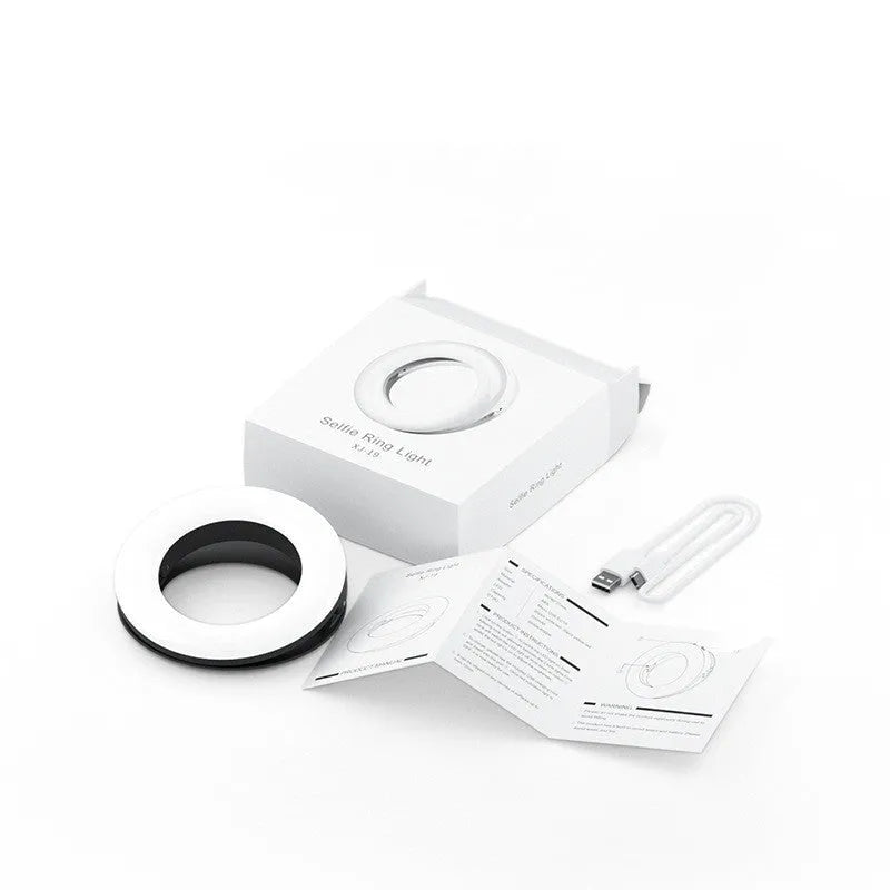 Compact black selfie ring light with USB cable for mobile phone photography and video lighting.