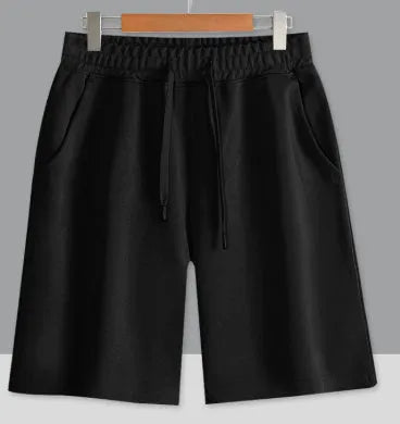 Men's and women's straight cut cotton sports shorts in multiple colours on a plain background.