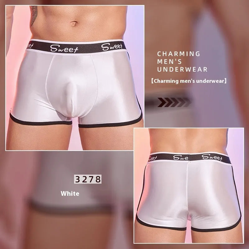 Man's shiny silky nylon boxer briefs in black, white, and sapphire blue colours laid flat.