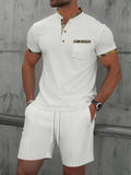Men's grey waffle texture short sleeve zip-up polo suit with matching shorts laid flat.