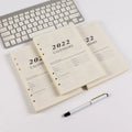 A5 loose-leaf notebook inner pages with monthly plan layout on white paper