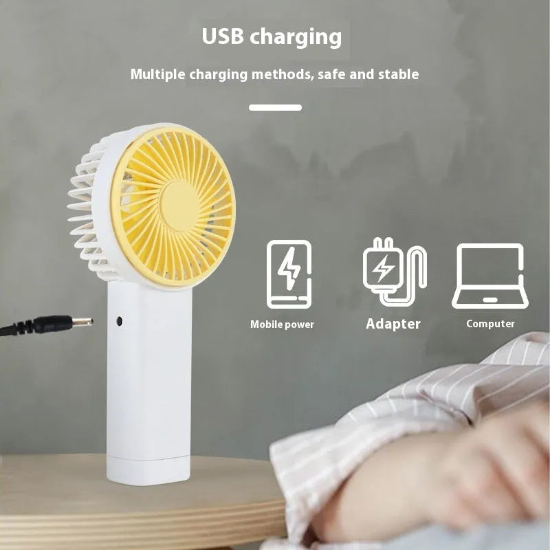Outdoor portable USB rechargeable handheld fan with three plastic blades, available in multiple colours and cartoon designs