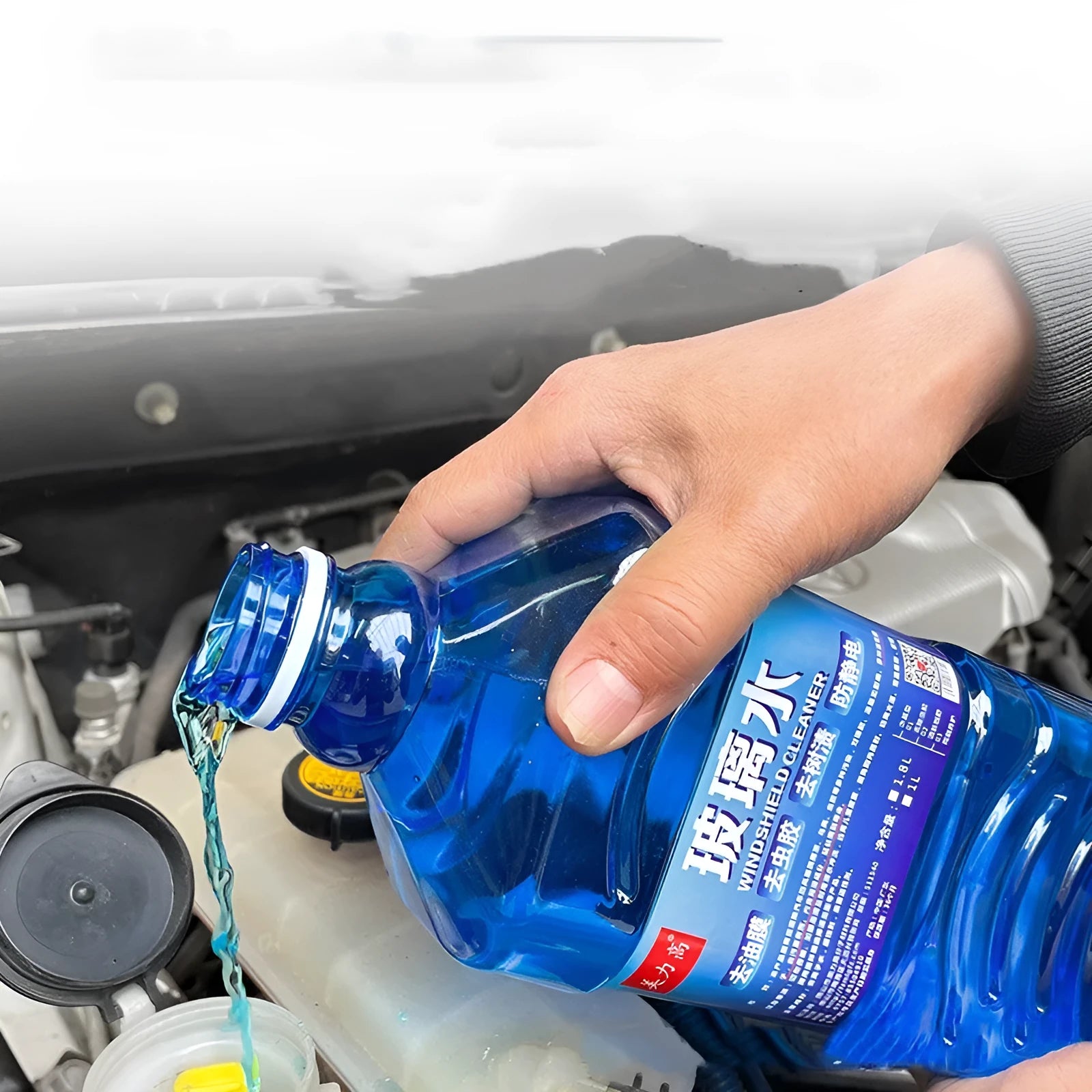 Blue windshield washer fluid in 1.8L bottle with car wiper application