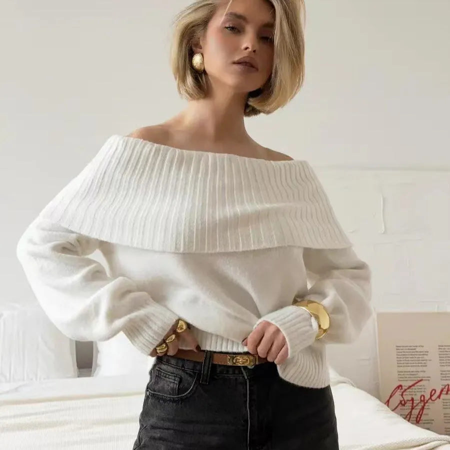 Woman wearing a grey off-the-shoulder sweater with a 3D textured pattern.