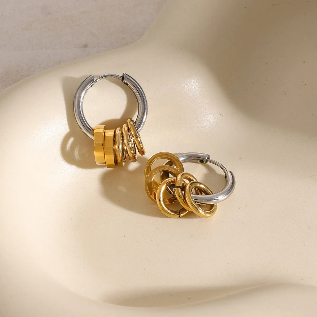A pair of stainless steel ins style earrings with an electroplated colour finish.