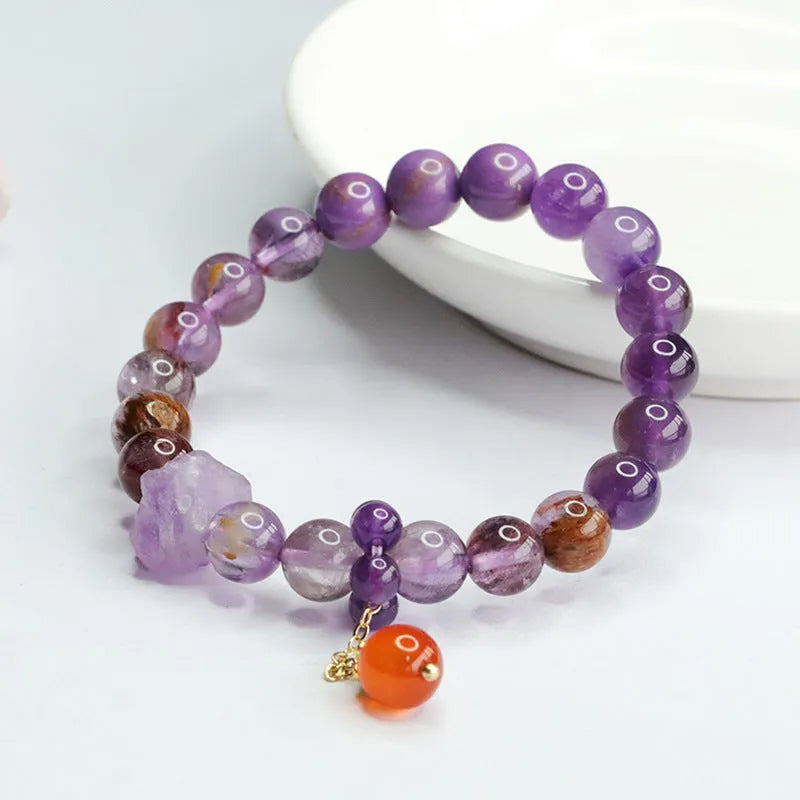 Natural Nine Purple Amethyst and red agate Mori style bracelet on wrist.