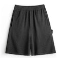Cement grey American-style loose profile straight-leg sports shorts with elastic waistband