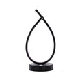 Black water drop shaped USB table lamp with touch control on wooden bedside table