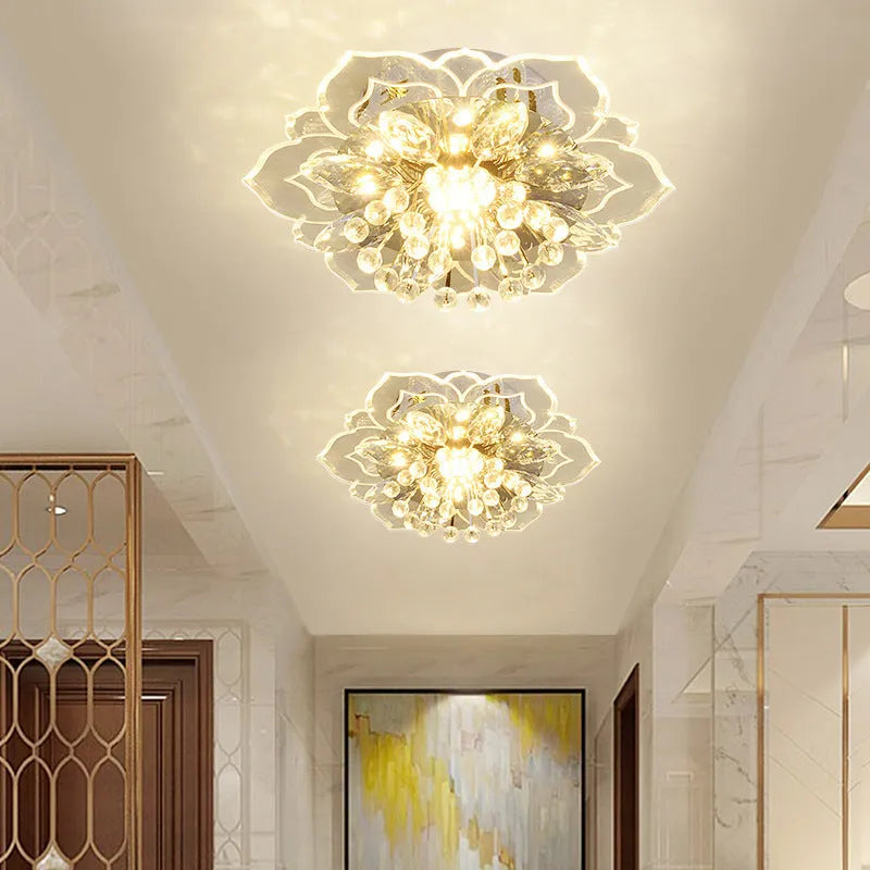 Small modern crystal and acrylic ceiling lamp with stainless steel fitting on a white ceiling.