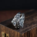 Silver open ring with detailed Jibeast and zodiac animal pattern, shown on a hand.