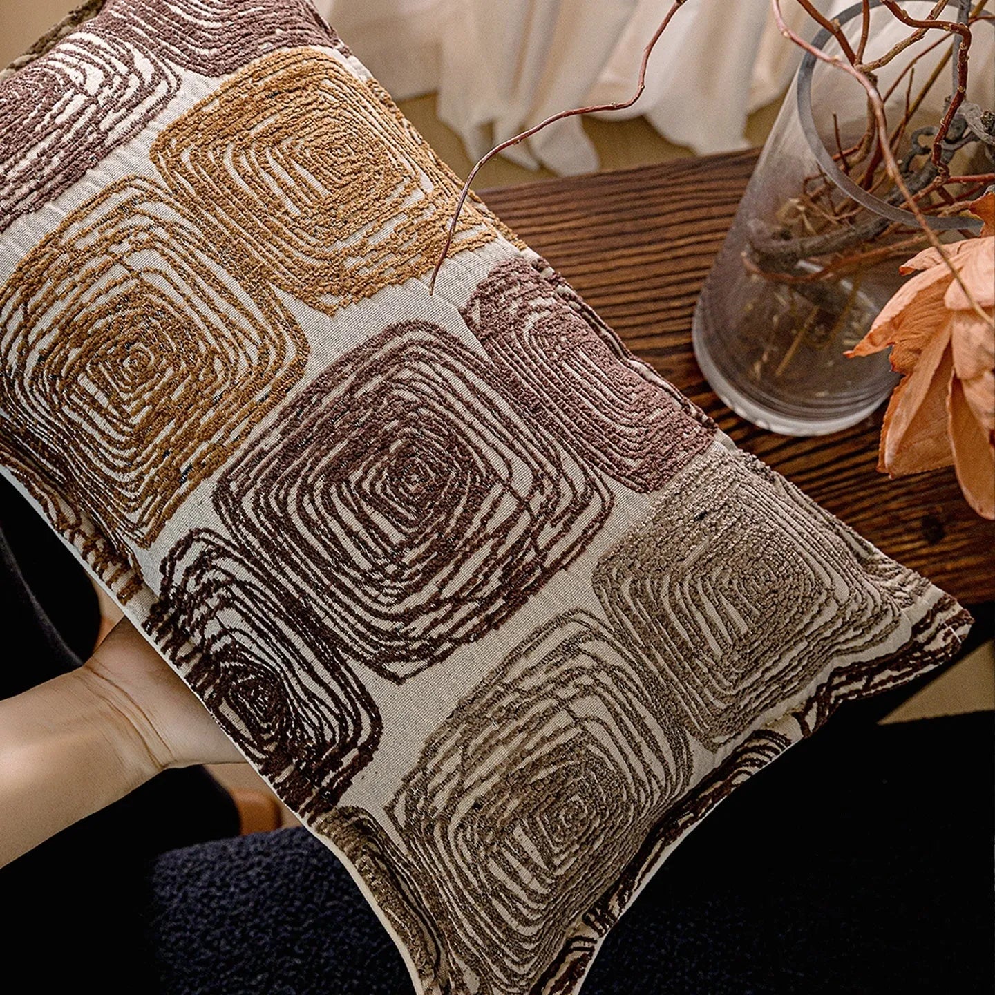 Abstract coil pattern cushion cover with piping trim in cream and coffee colours