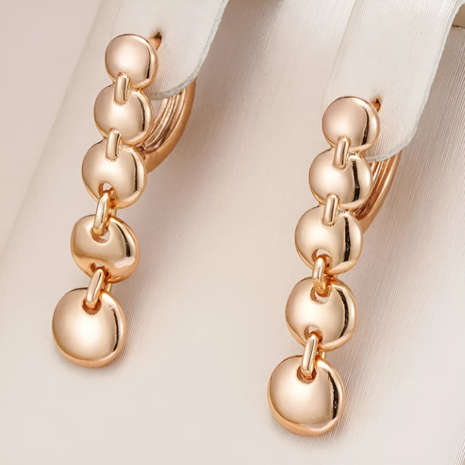 A pair of gold-coloured retro long round circle earrings with a woven copper texture.