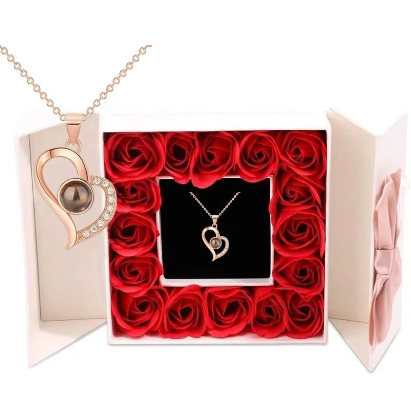 Rose gold heart-shaped projection necklace in copper with O chain, displaying 100 languages love message.