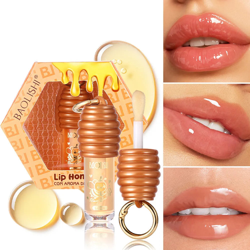 Honey lip gloss on a silver keychain clip against a neutral background.