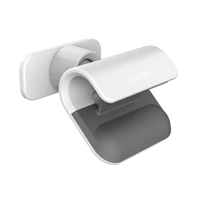 Black universal gravity car phone holder with 360-degree rotation pivot on a car dashboard