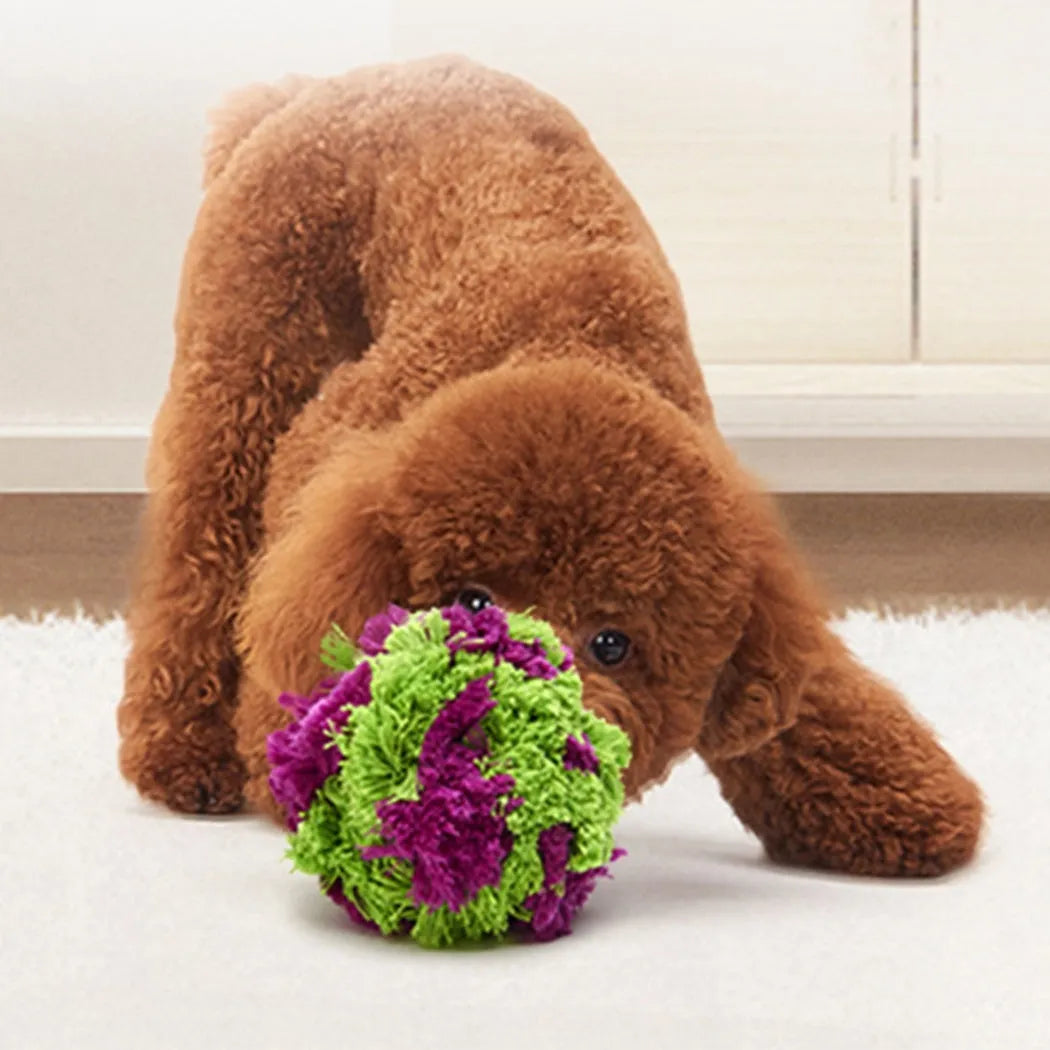 Purple plush dog sea ball chew toy with white knot designs, approximately 15cm diameter