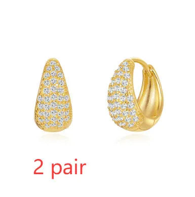 Brass geometric earclip earrings with gold electroplated finish and round design elements