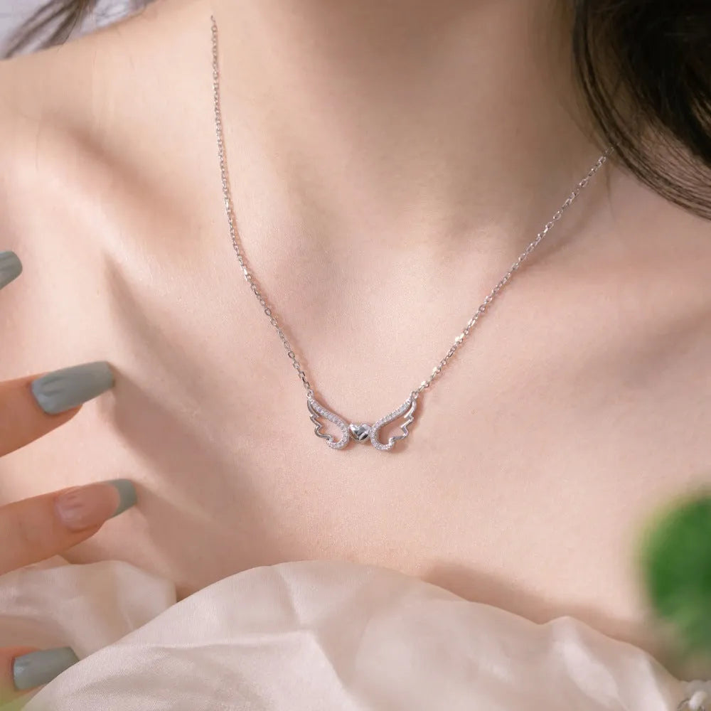 Women's 925 silver hollow-out wings love necklace on display