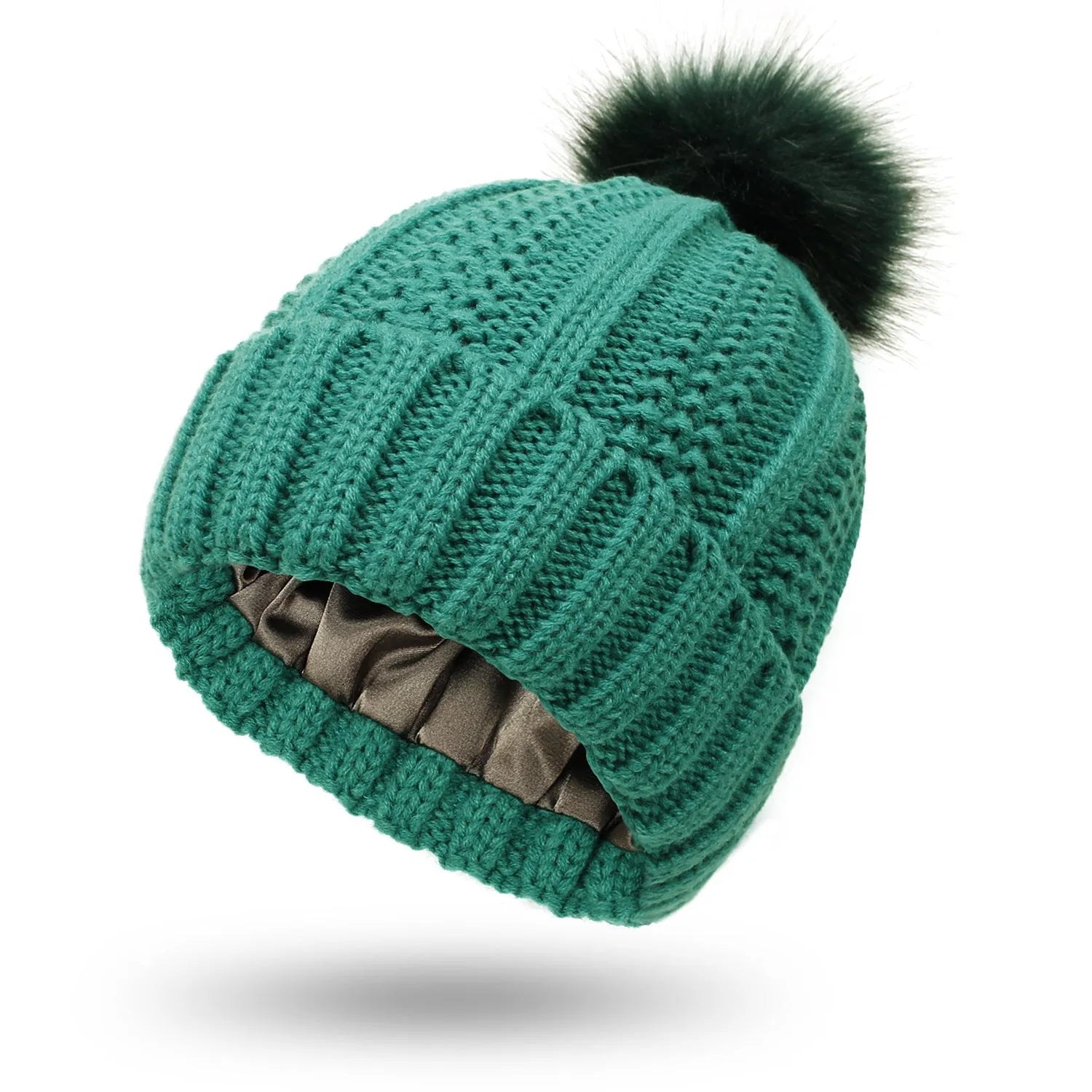 Women's beige wool knit beanie hat with a faux fur pom pom and a satin lining visible at the brim.