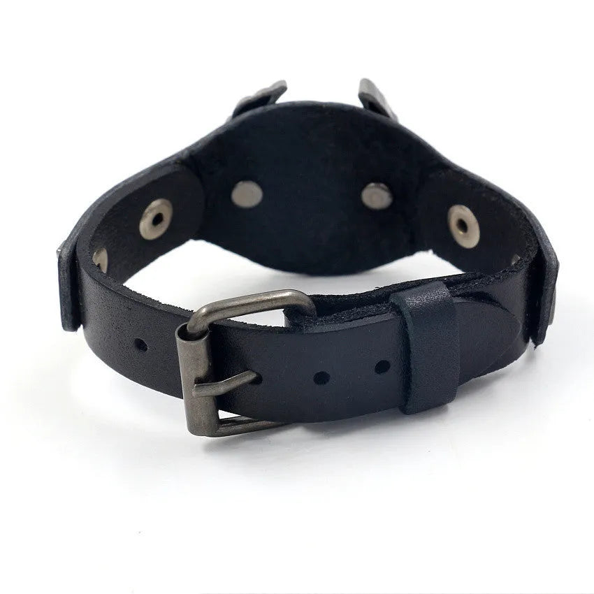 Black geometric bracelet with eagle watch-button closure on leather strap showing adjustable width design