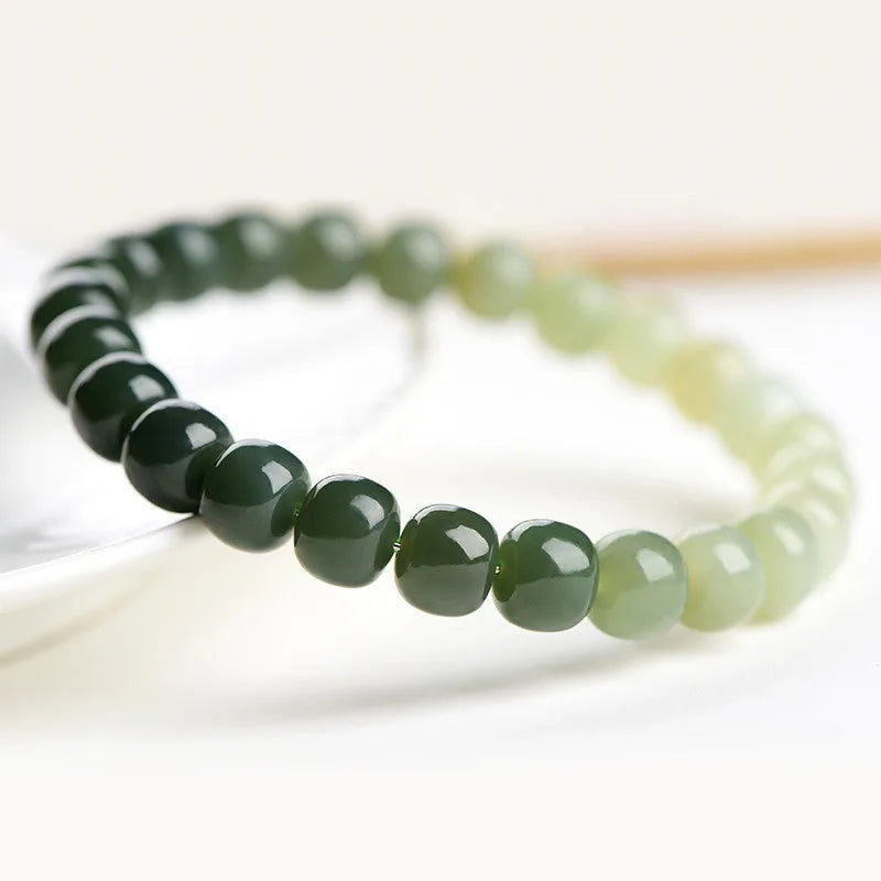 Polished Hetian Jade bracelet showing a gradient water colour on beads.