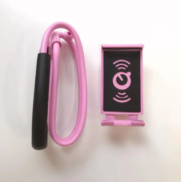 White plastic and foam 360-degree rotatable universal phone holder on a table.