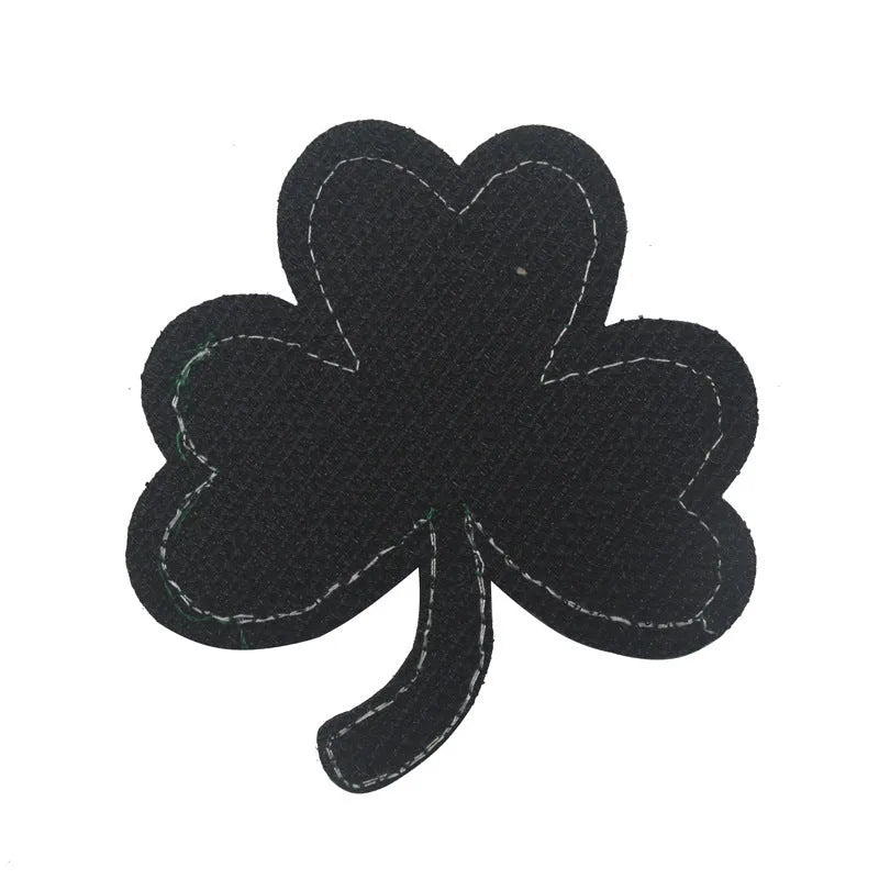 Embroidered fabric badge with Velcro backing showing military-style clover and skull flower designs