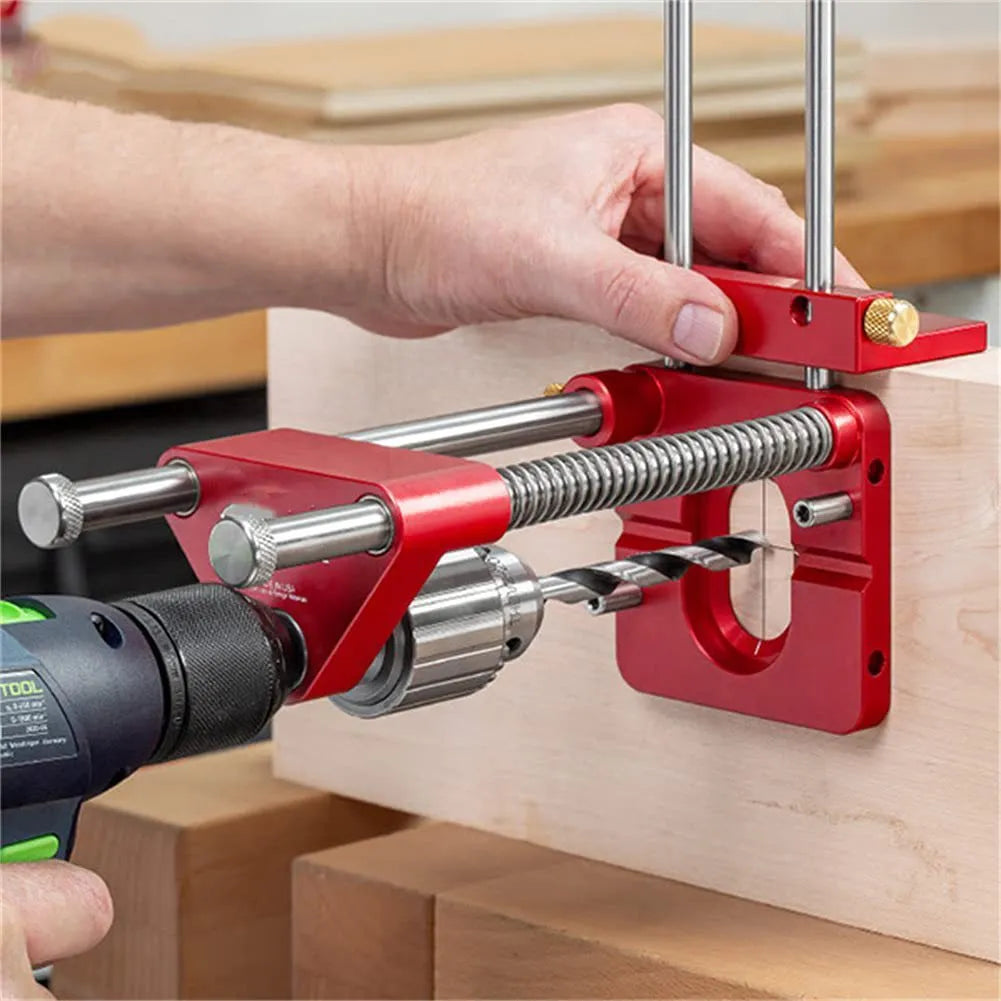 Red alloy steel woodworking drill locator on wood surface with plastic components