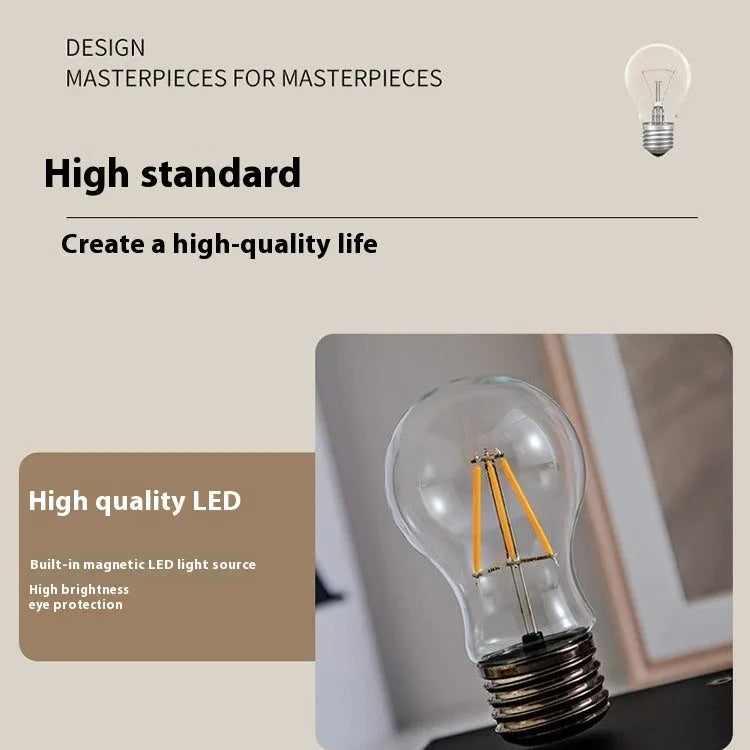 Black iron art suspension bulb night lamp on a wood grain base for desktop decoration.