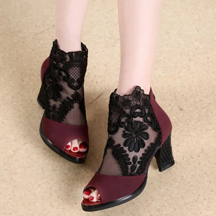 Black women's gladiator sandals with lace upper, square heel, zip closure, and peep toe.