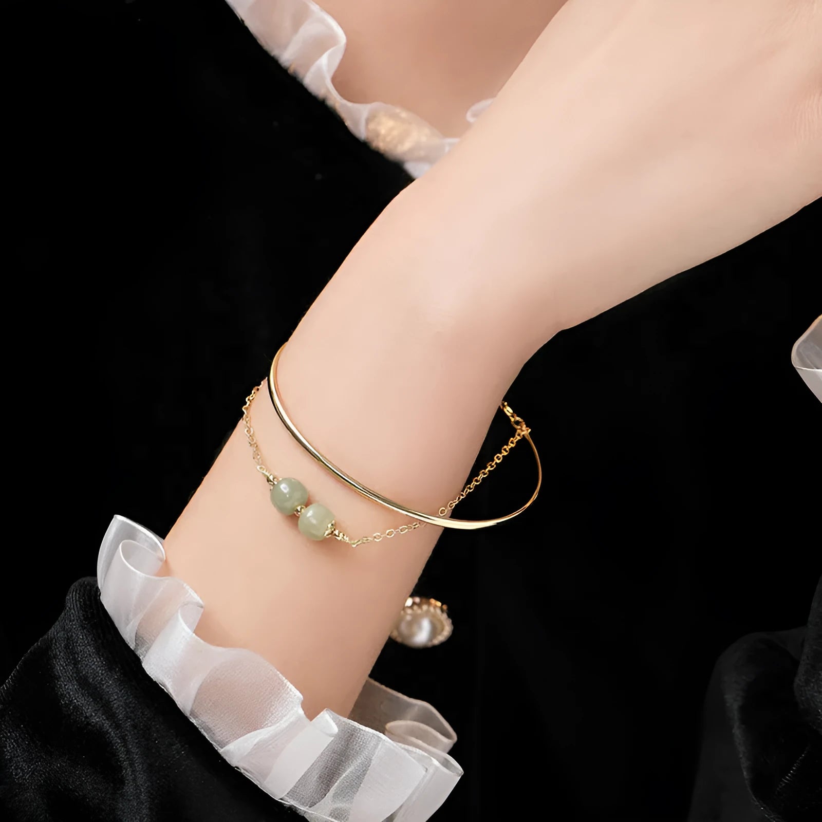 Hetian jade bracelet with gold inlay in single, double, and three bead versions on a wrist.