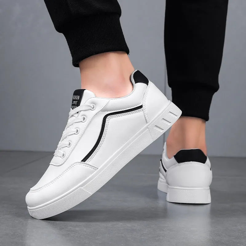 Korean style low top board sneakers in black with white stitching and a flat rubber sole.