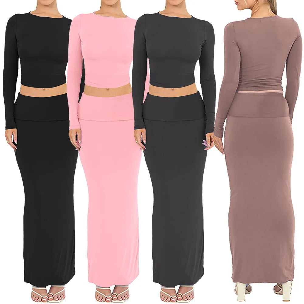 Women's black two-piece suit set with three-quarter sleeve top and long skirt on a mannequin.