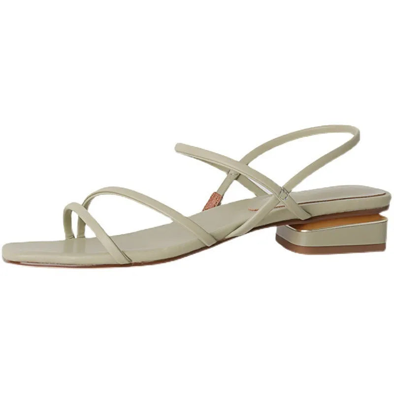 Women's beige flat strap Roman sandals with square open toe on a neutral background