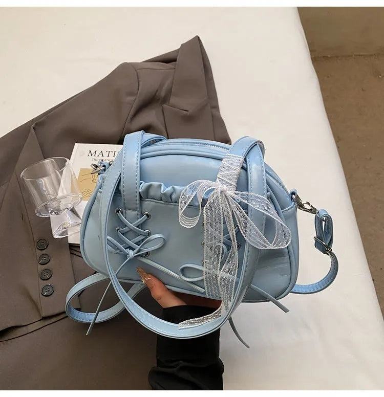 PU leather ladies shoulder handbag with phone compartment in milky white colour showing decorative stitching