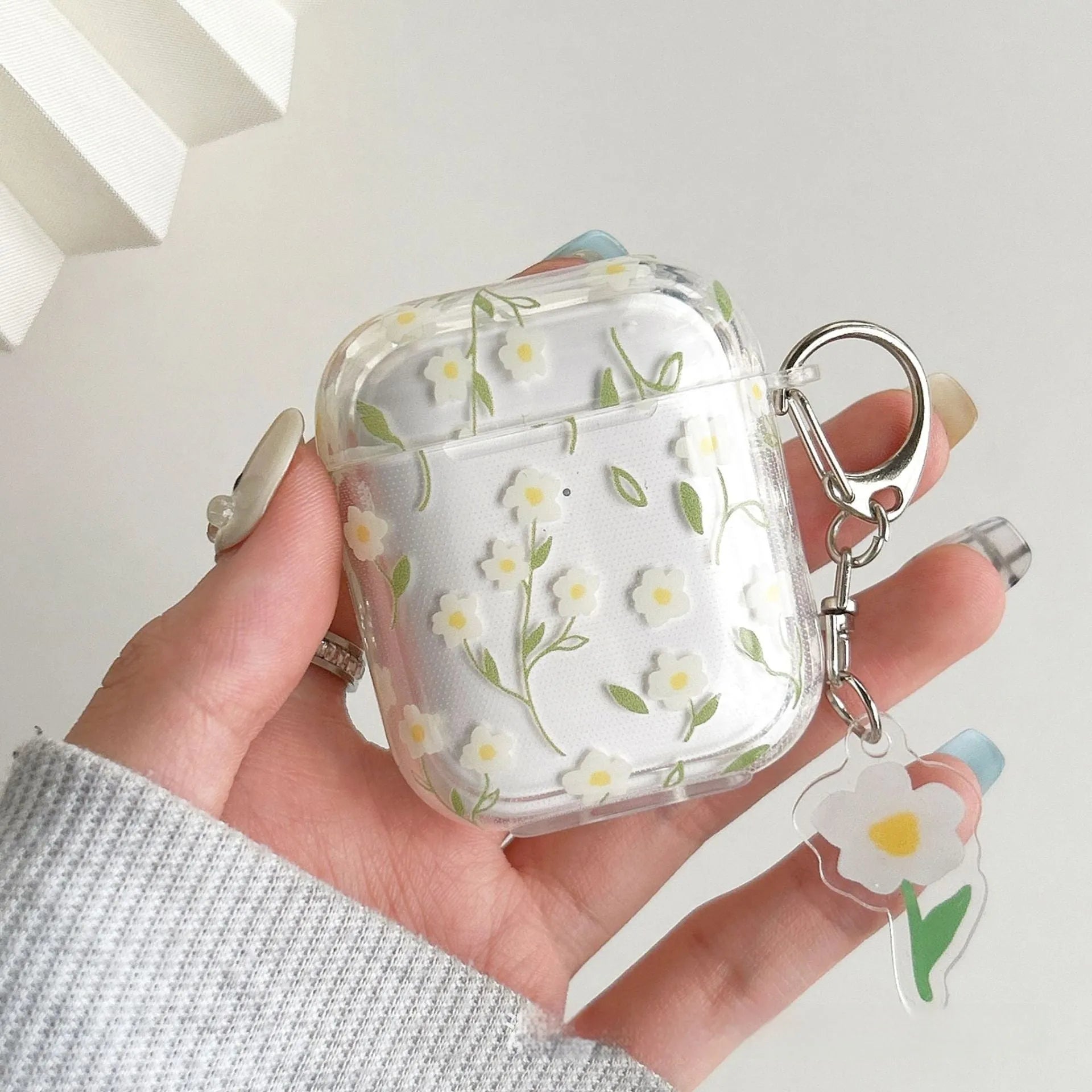 White floral patterned transparent TPU protective cover for Apple AirPods showing compatibility with multiple models