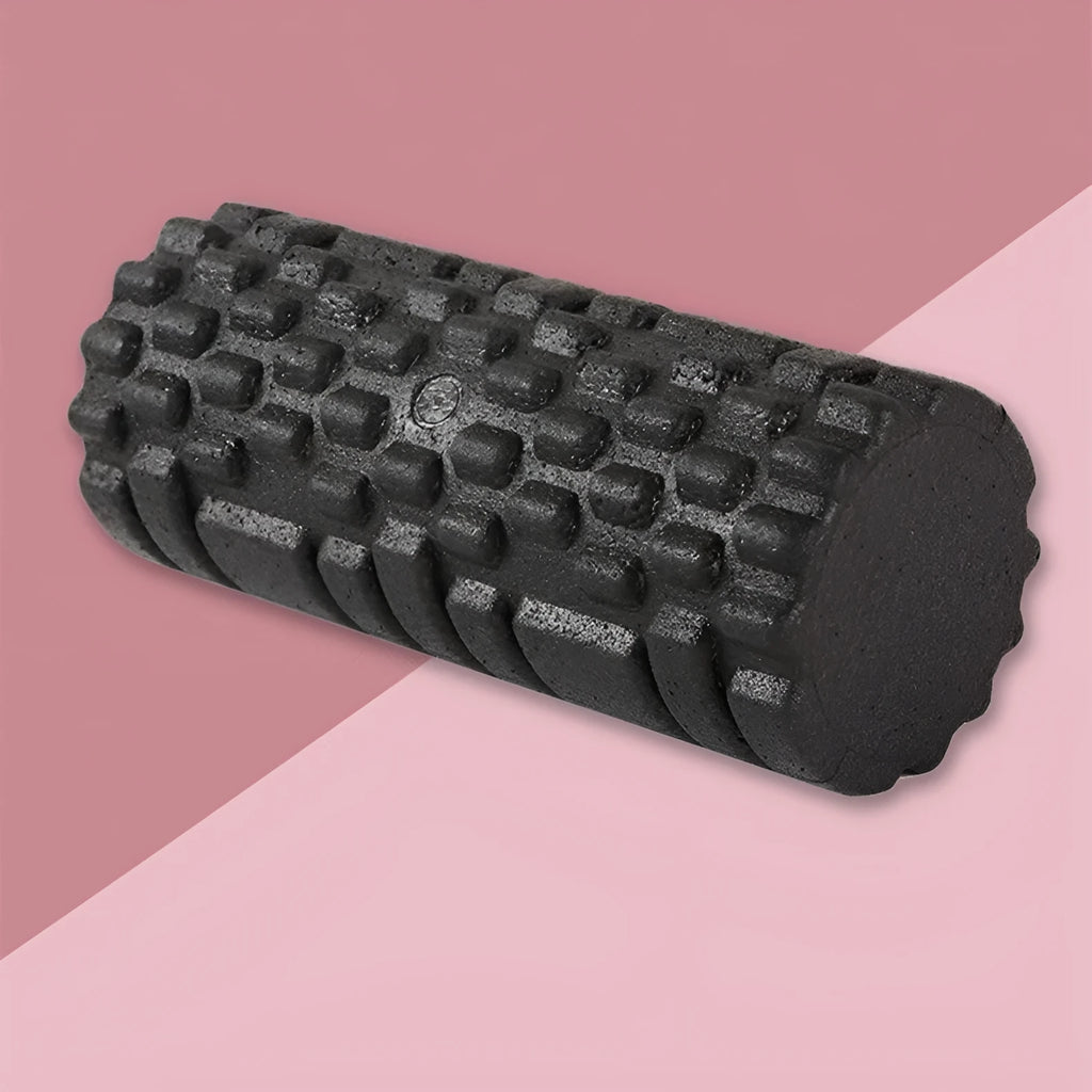Hollow black EPP foam roller 33x14cm on a white background for Pilates and balance exercises