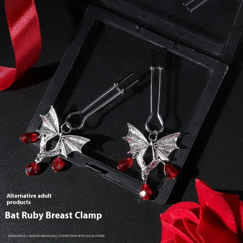 Silver diamond bat design nipple clamp with ruby accents and adjustable tension mechanism
