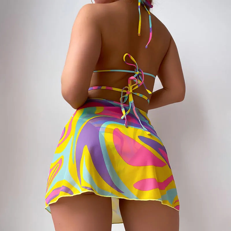 Yellow striped halter neck swimsuit set for women, showing top, skirt, and shorts with lace-up detail.