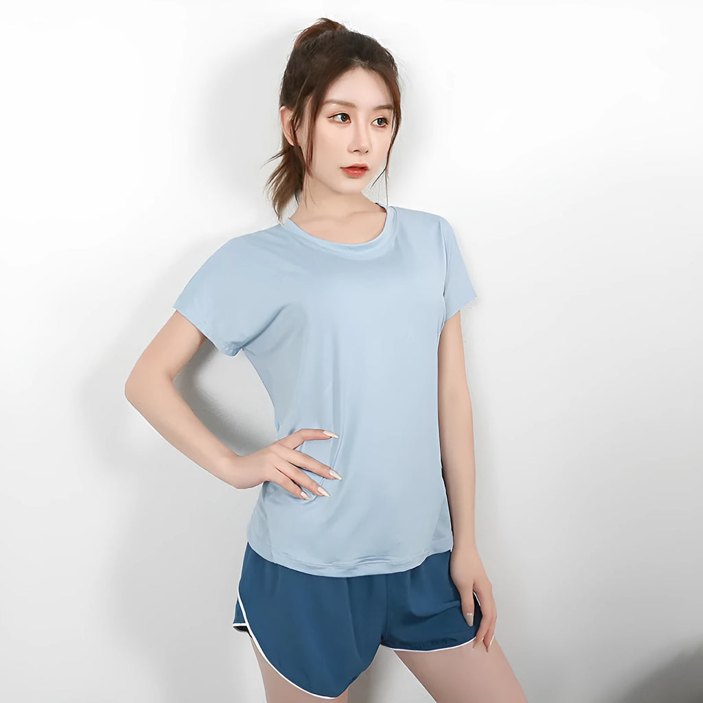 Ladies short sleeve polyester sports T-shirt in pink, shown on a hanger.