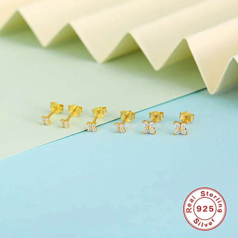 S925 sterling silver stud earrings with small petal-shaped crystal flowers in gold or platinum finish.