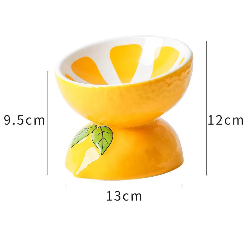 Ceramic raised cat bowl in orange pattern, showing tilted wide dish on non-slip base.