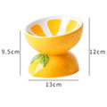 Ceramic raised cat bowl in orange pattern, showing tilted wide dish on non-slip base.